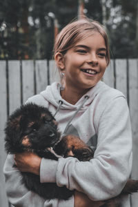 Portrait of a smiling young woman with dog