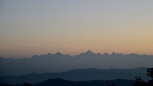 Scenic view of silhouette mountains against sky during sunset