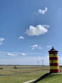 Scenic view of field against sky and lighthouse