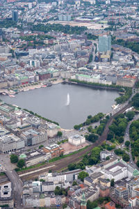 High angle view of buildings and lake in city