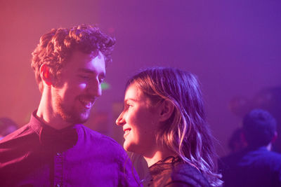 Smiling couple in nightclub