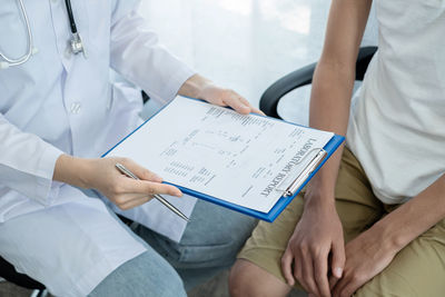 Midsection of man using laptop