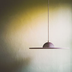 Close-up of illuminated lamp hanging on wall