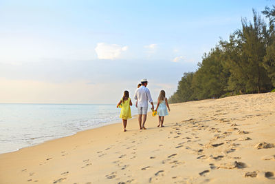 Rear view of people on beach