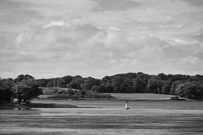 Scenic view of golf course against sky