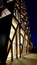 Low angle view of illuminated building against sky at night