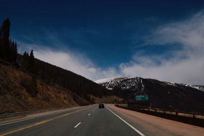 Country road leading towards mountains