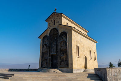 Low angle view of building against clear blue sky