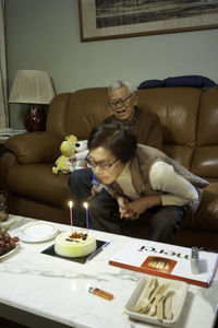 People sitting on sofa at home