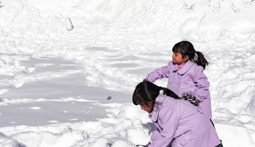 Rear view of woman in snow during winter