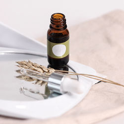 Close-up of bottle in mirror on table