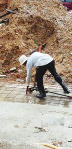 Rear view of man skateboarding on land