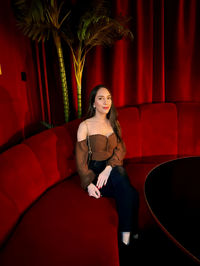 Portrait of young woman sitting on stage