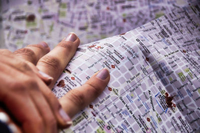 Cropped hands of woman holding map