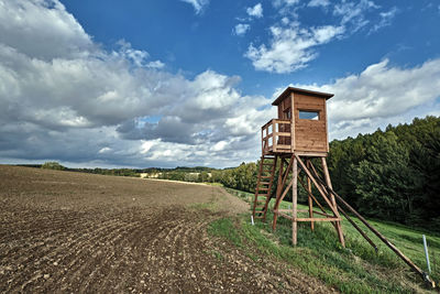 Built structure on field against sky