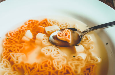 Close-up of heart shape pasta soup in plate