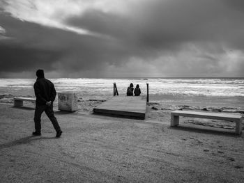 People on beach against sky