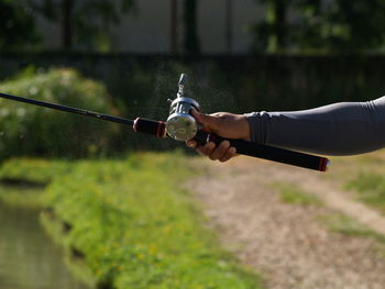 Cropped hand fishing outdoors