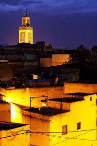 Illuminated bell tower against sky at night