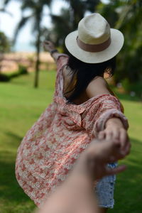 Close-up of model looking away, while trying to hold her hands.