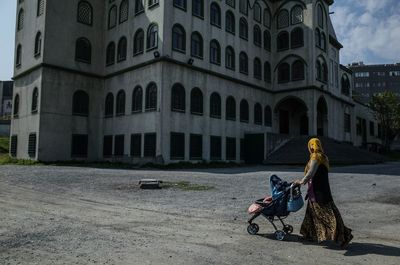 Woman sitting in front of building