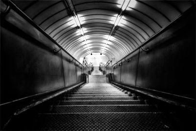 Man walking in illuminated tunnel