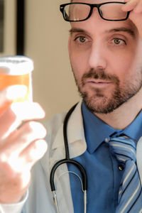 Close-up of doctor holding bottle
