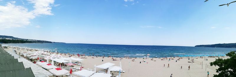 Scenic view of beach against blue sky