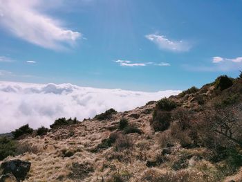 Scenic view of mountains against cloudy sky