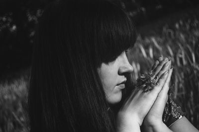 Close-up of young woman holding cat against trees