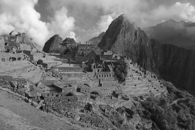 Panoramic view of mach picchu ruins against cloudy sky