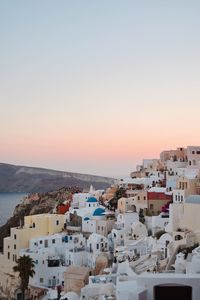 High angle view of townscape by sea against sky during sunset