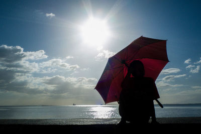 People on beach against sky