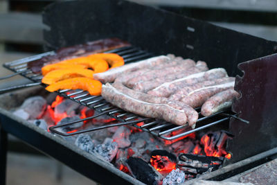 High angle view of bratwurst on barbecue grill