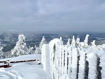 Frozen sea against sky during winter