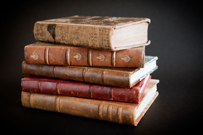 Close-up of stack of food on table against black background