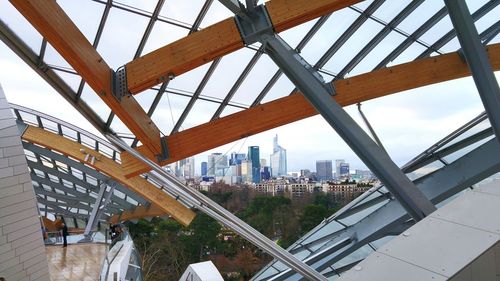 Modern bridge in city against sky