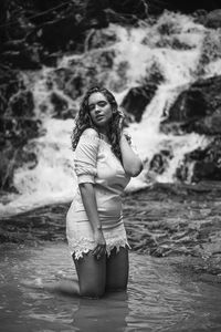 Portrait of woman standing in water