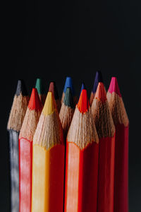 Close-up of colored pencils against black background