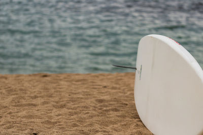 Close-up of white boat on beach