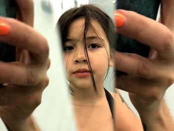 Close-up portrait of girl holding hands