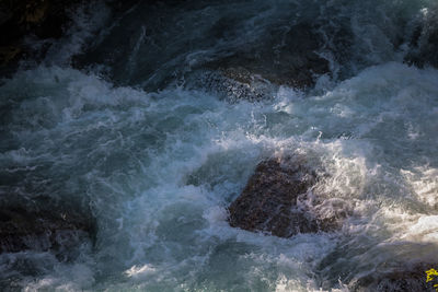 Water flowing through rocks in sea