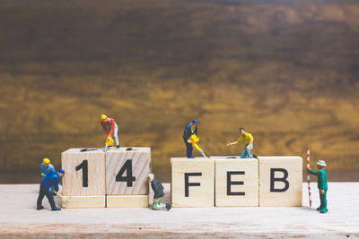 Figurines of workers with text and date on table