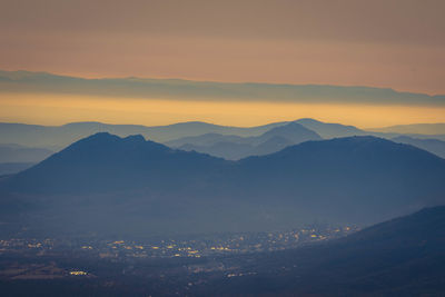 Scenic view of mountains against sky during sunset