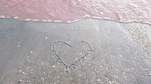 High angle view of heart shape on sand