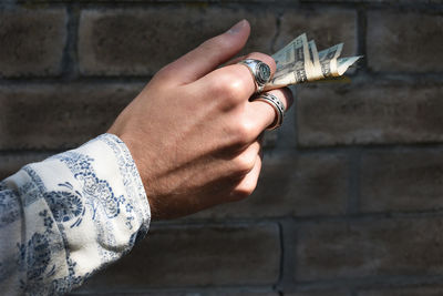 Cropped hand of man holding cash