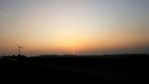 Scenic view of silhouette field against sky during sunset