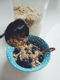 Rolled oats with blueberries in bowl on table
