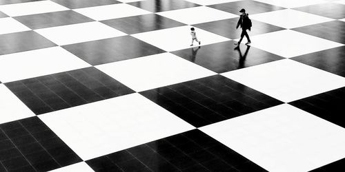 High angle view of man standing on tiled floor