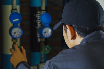 Rear view of man working in factory